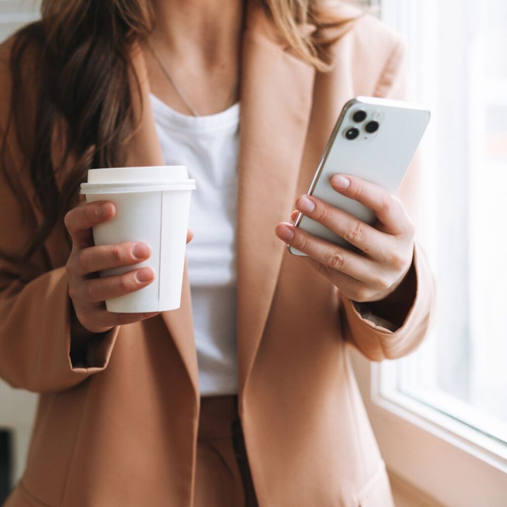 Creative business owner using her cell phone to market her business on Social media 