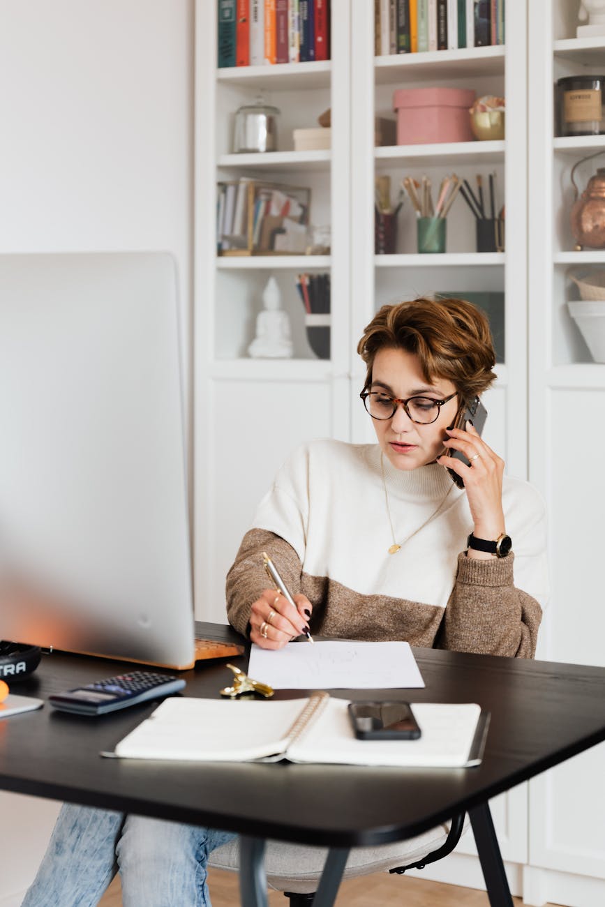 modern businesswoman in casual outfit talking on mobile in office